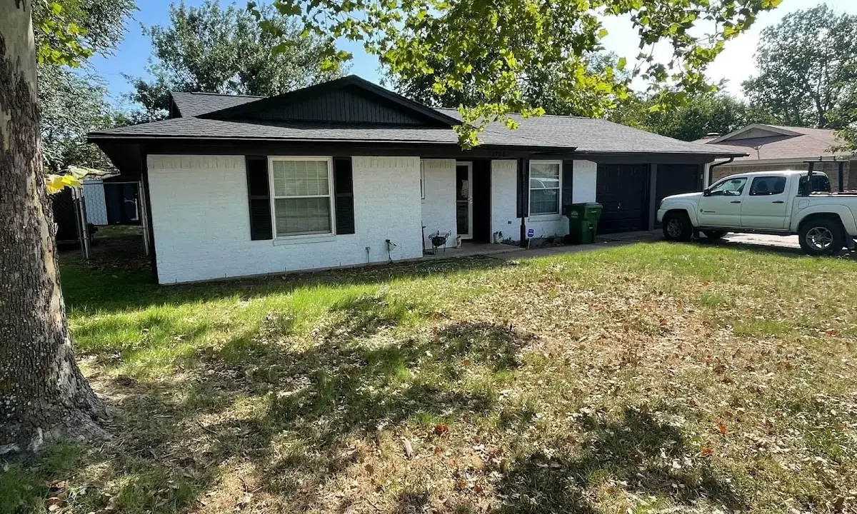 Professional roofing crew working on a residential roof in Huron